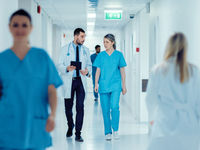 The%20surgeon%20and%20the%20female%20doctor%20walk%20through%20the%20hospital%20corridor